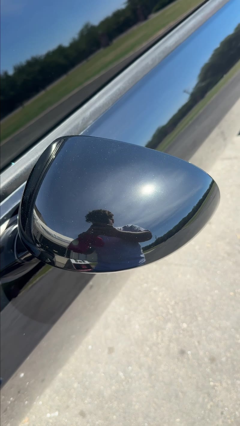 Mirror-like gloss on a black car after paint correction and ceramic coating